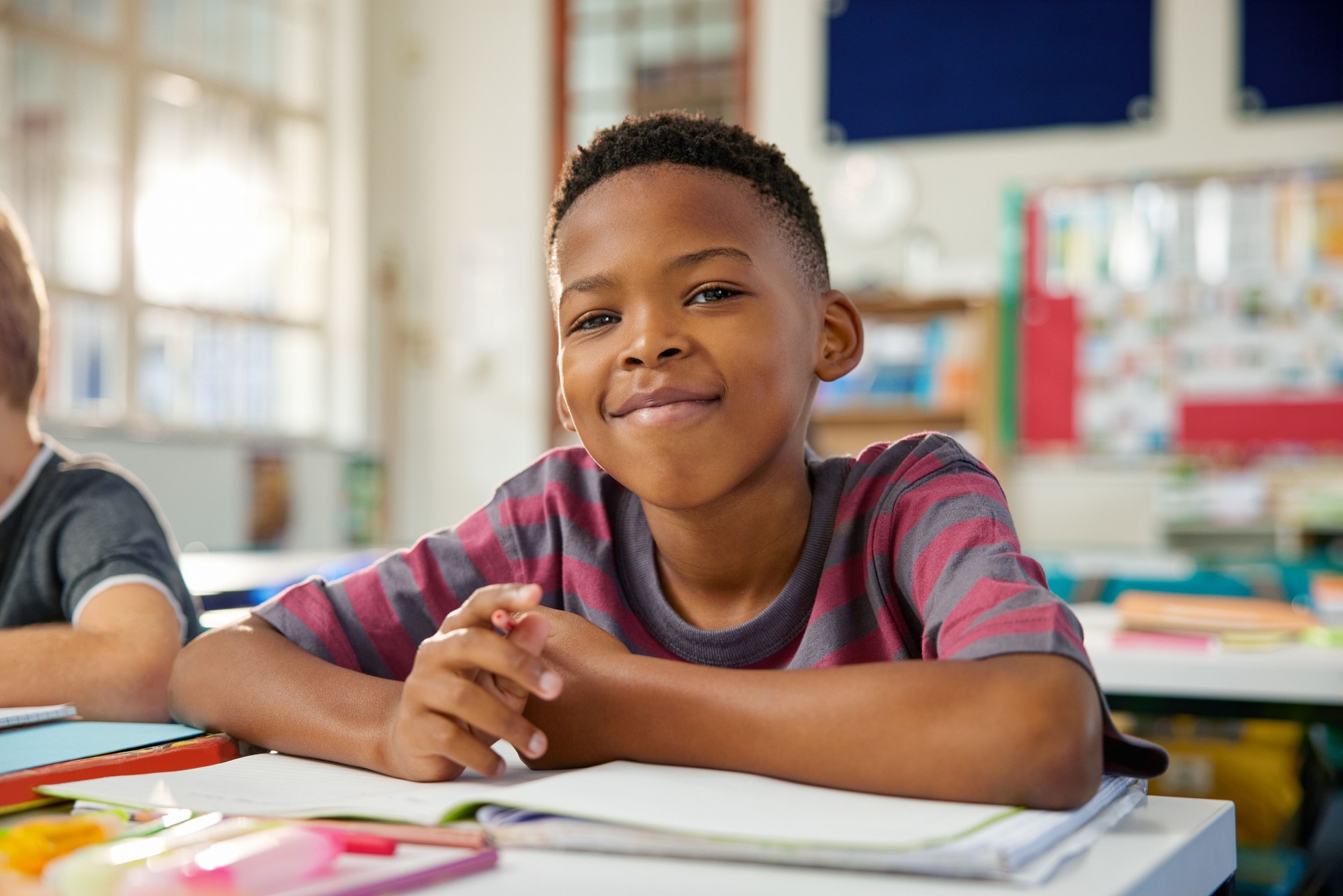 Portrait of african american child sitting at desk at elemetary school